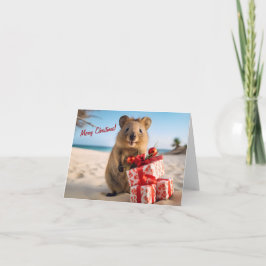Carte Joyeux Noël Quokka sur la plage avec des présents