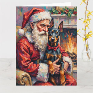 Carte L'art de Noël de Santa Claus tenant un Doberman