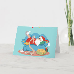 Carte Père Noël sur le canapé en pyjama