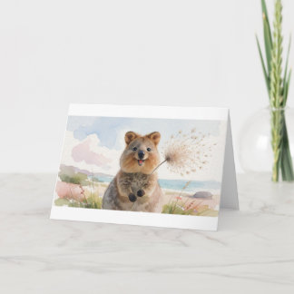 Carte Quokka soufflant une tête de graine duveteuse dans