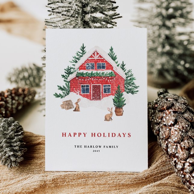 Cartes Pour Fêtes Annuelles Cosy Aquarelle Rouge Cottage Forêt À feuillage per (This holiday card features a beautifully illustrated red cottage nestled in a snowy evergreen forest)