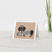 Voleur de friandises teckel noir et marron oiseau