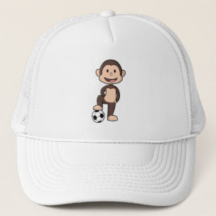 Casquette Singe comme joueur de football avec balle de footb