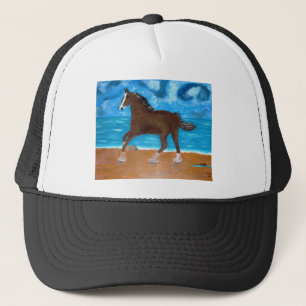 Casquette un cheval sur la plage