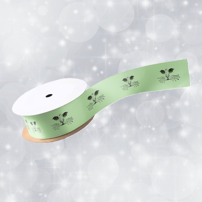 Cat Face Green Eyes Whiskers Satinband (black illustration of the face of a cat long whiskers green eyes on roll of green gift wrap ribbon.)