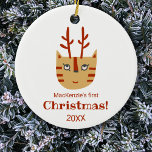 Cat First Christmas Keramik Ornament<br><div class="desc">Eine niedliche und unterhaltsame Katze mit Geweihten,  die dich zum Lächeln bringt. Zurück zeigt ein passendes Muster. Ändern Sie den Namen und das Jahr,  um zu personalisieren. Originelle Kunst von Nic Squirrell.</div>