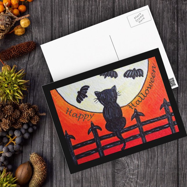 Chat d'Halloween sur une clôture dans la carte pos (Black Cat on fence full moon bats on Happy Halloween postcard.)