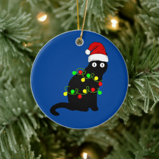 Chat noir et ornement des lumières de Noël