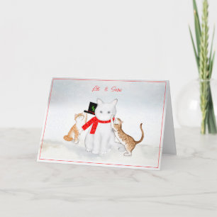 Chats jouant dans la carte de Noël de neige