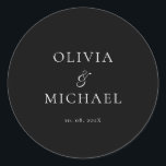Chic Script Black Minimalist Wedding Runder Aufkleber<br><div class="desc">Add a personal and elegant touch to your wedding favors, envelopes, or packaging with this minimalist round sticker featuring your custom name in a graceful script font. Designed to complement a modern and timeless wedding theme, this classic black-and-white design pairs beautifully with any part of your celebration. Perfect for sealing...</div>