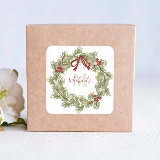 Christmas Elegant Wreath Red Holly Monogram Quadratischer Aufkleber (Christmas holiday greenery and red holly berries wreath with red ribbon sticker. )