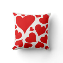 Coeurs rouges sur le coussin blanc d'amour