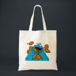Cookie Monster Eating All the Cookies Tragetasche<br><div class="desc">Satisfy your cravings for fun and cookies with this graphic featuring the one and only Cookie Monster! This showcases a vibrant illustration of Cookie Monster in his element, happily devouring a pile of chocolate chip cookies with crumbs flying everywhere. This classic and instantly recognizable design is cheerful, playful, and sure...</div>