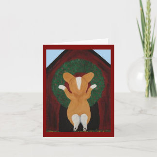 Corgi hängt Weihnachtskranz an das Hundehaus Karte