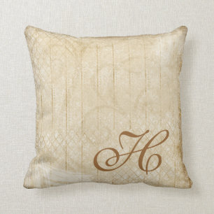 Coussin affligé de décor de monogramme d'or et d