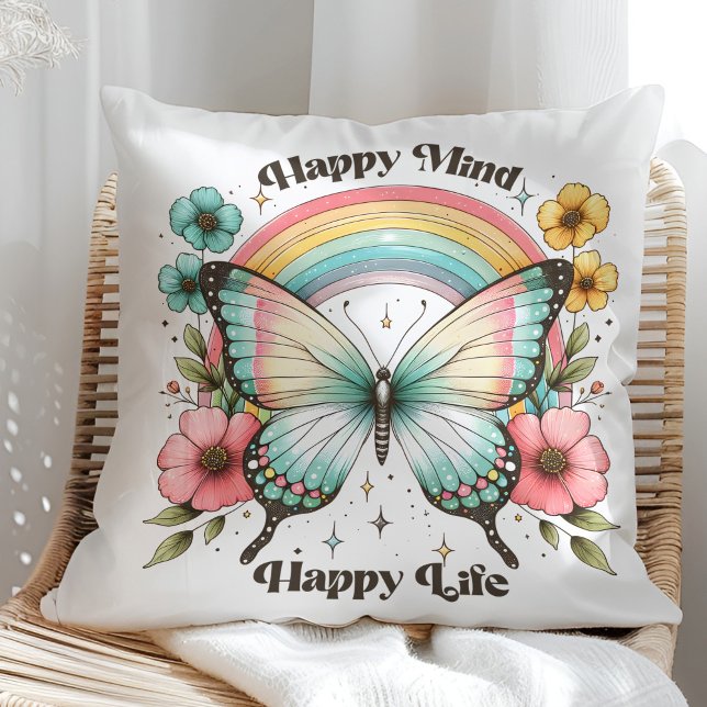 Coussin "Happy Mind Happy Life" Papillon Pastel Arc-en-cie ("Happy Mind Happy Life" Pastel Butterfly Rainbow Throw Pillow in a sunny rattan armchair.)