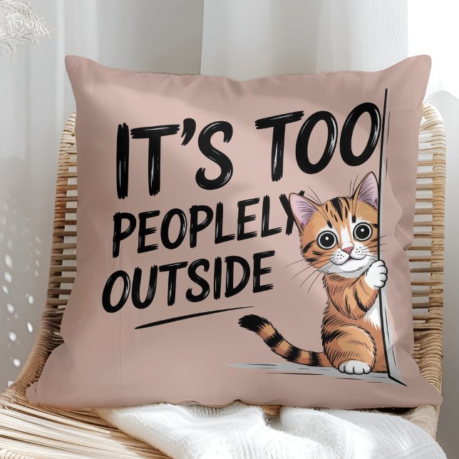 Coussin "It's Too Peopely Outside" Funny Introvert Cat ("It's Too Peopely Outside" Funny Introvert Cat Throw Pillow in a sunny boho rattan chair.)