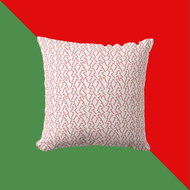 Coussin Motif sucre de canne rouge et blanc (A throw pillow with a red and white candy cane Christmas pattern)