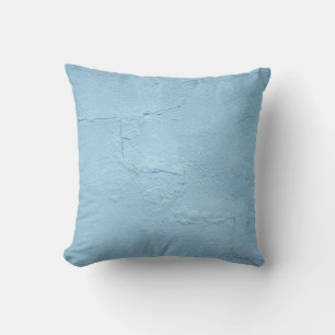 Coussin Mur en béton peint bleu en journée