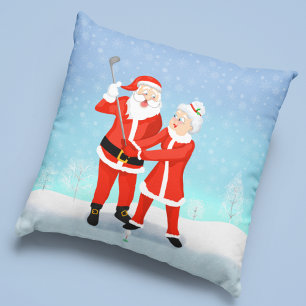Coussin Père Noël aidant Mme Claus à améliorer son swing d