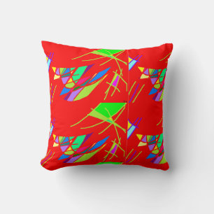 Coussin rouge avec motifs bleu vert