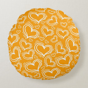 COUSSINS RONDS ORANGE LUMINEUX AVEC COEURS BLANCS ET FLEURS