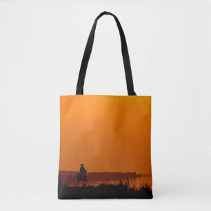 Cowboy Männer reiten auf Pferden bei Sonnenunterga Tasche