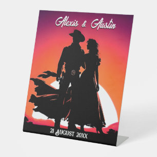 Cowboy und Cowgirl bei Sonnenuntergangs-Hochzeit Sockelschild