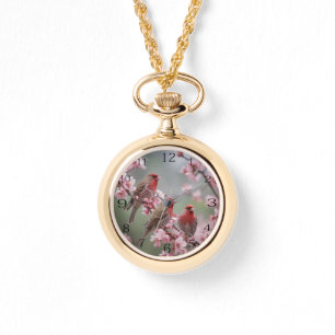 "Crimson Trio: Rote Finches inmitten rosa Blüten" Armbanduhr