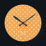 Custom Monogram. Orange and White Polka Dot. Runde Wanduhr<br><div class="desc">A customizable monogram initial letter on a background of an orange and white polka dot pattern. The letter can be personalized.</div>