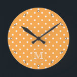 Custom Monogram. Orange and White Polka Dot. Runde Wanduhr<br><div class="desc">A customizable monogram initial letter on a background of an orange and white polka dot pattern. The letter can be personalized.</div>