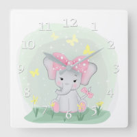 Cute baby elephant with a pink bow in a clearing