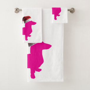 Dachshund mignon portant un chapeau de Père Noël