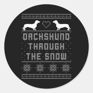 Dackel durch den schneebedeckten Weihnachtssüßer Runder Aufkleber