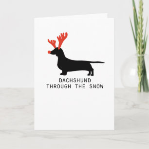 Dackel durch die Weihnachtskarte des Schnees Feiertagskarte