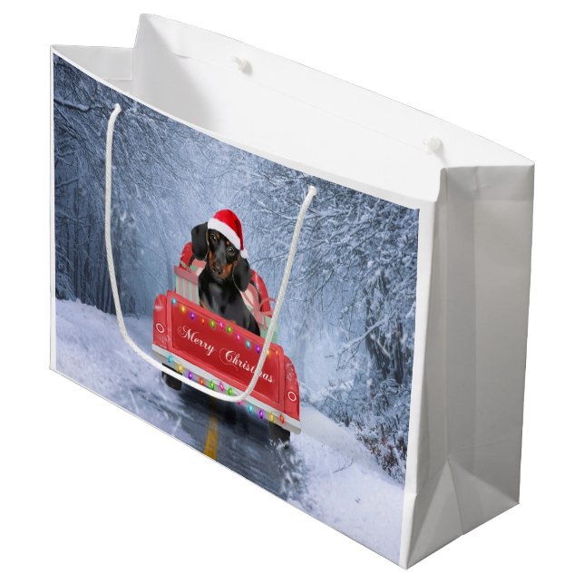 Dackel Hund im Schnee sitzen im Weihnachtswagen Große Geschenktüte (Vorderseite Schrägansicht)
