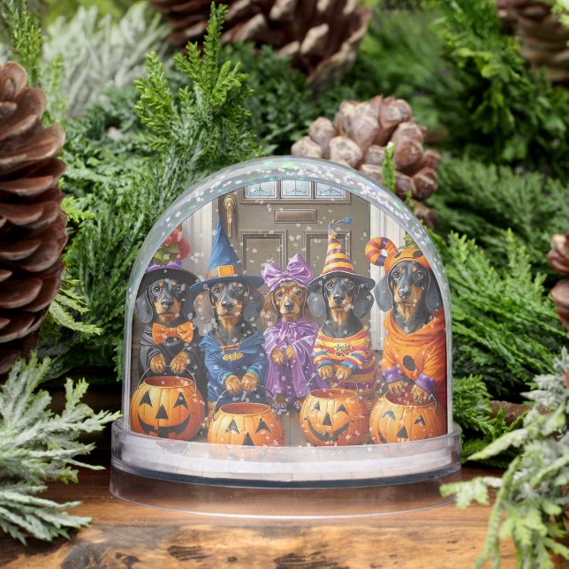 Dackeln-Trick oder Schneeglobe behandeln Schneekugeln (Winter)