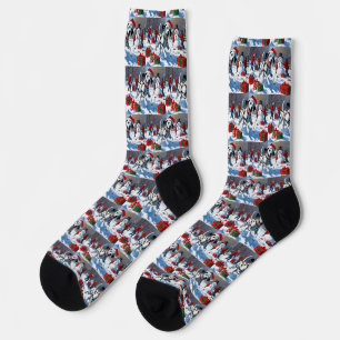 Dalmatiner läuft im Schnee mit Weihnachtshut Socken