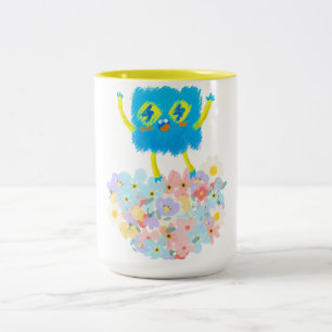 Der glückliche blaue Kritzel auf einem Blumenbett Zweifarbige Tasse