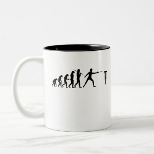 Die Evolution des Golfplatzes Zweifarbige Tasse