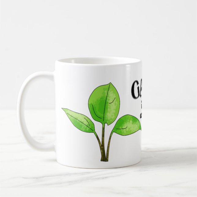 Die Gartenarbeit ist eine Übung im Optimismus Kaffeetasse (Links)