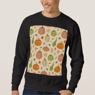 Die Kürbis sind grün und orange, das Muster ist na Sweatshirt
