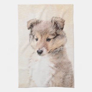 Die Shetlandinseln-Schäferhund-Welpe, der Geschirrtuch