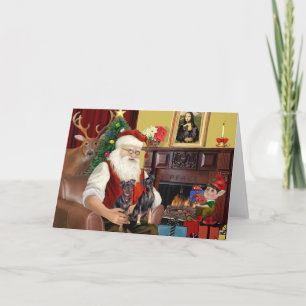 Die zwei Miniaturpinschers des Weihnachtsmanns. Feiertagskarte