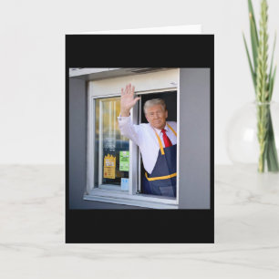 Donald Trump arbeitet an der Fritteuse und hält ei Karte