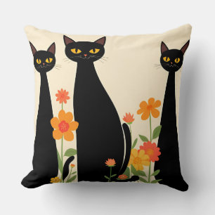 Drei schwarze Katzen unter leuchtenden Blumen Kissen