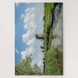 Drei Windmühlen und ein Kanal mit Booten in Hollan