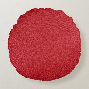 Dunkelrotes Kunstleder in der Nähe. Rundes Kissen