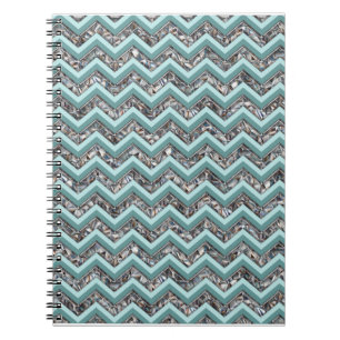 Dunkles geschliffenes Glas und aquamariner Notizblock