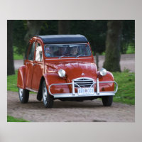Ein altes, rotes Citroen 2CV Auto mit einer lächel